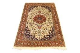 A Persian style wool rug on a beige ground.