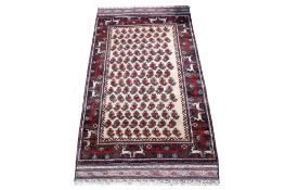 A small cream ground rug.