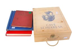 A collection of assorted world stamp albums and a wooden box of loose stamps.
