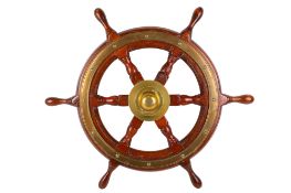 A Simpson Lawrence brass bound oak ship wheel.