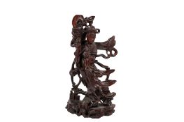 A Chinese carved rosewood figure of a female immortal, possibly Guanyin.