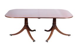 A Regency style mahogany twin pillar extending dining table.