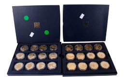 Two boxed sets of coins.