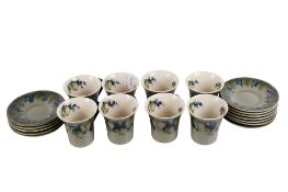 A set of William Moorcroft coffee cups and saucers. Circa.