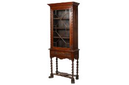 A 19th century oak astragal glazed cabinet on stand.