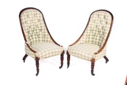 A pair of early 20th century mahogany framed button back chairs.