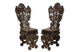 A pair of 19th century carved Sgabello hall chairs.