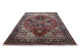 A large Heriz Kadjar rug, with label for Louis De Poorfore. 347cm x 250cm.