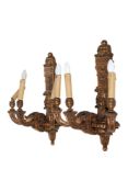A pair of Louis XVI style giltwood elaborately carved wall sconces.