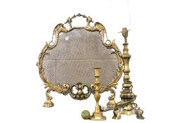 Three brass items. Comprising a fire screen, a table lamp, and a candlestick. Max.
