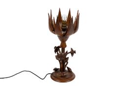 An articulated wooden 'lotus' flower table lamp.