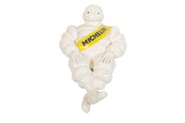 A plastic 'Michelin man' truck mascot figure.