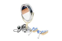 A three piece dressing table set and a cosmetic mirror.