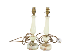 Pair of onyx carved stone and brass table lamps. Of baluster form raised on circular bases.
