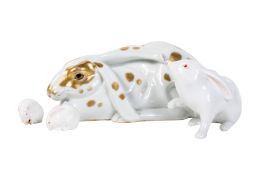 Three porcelain rabbit figurines and a mouse.