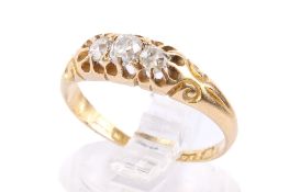 An 18ct gold ring. Set with three small diamonds, hallmarked, size N, gross weight 2.8g.