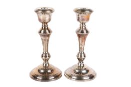 A pair of Elizabeth II weighted silver candlesticks.