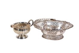 A late 19th/early 20th century Britannia silver basket and a Victorian milk jug.