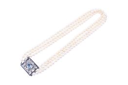 A three strand cultured akoya pearl necklet.