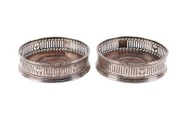A pair of 19th century white metal bottle coasters.