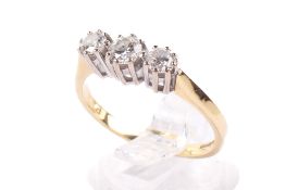 An 18ct gold and three stone diamond ring. The larger central stone circa 0.