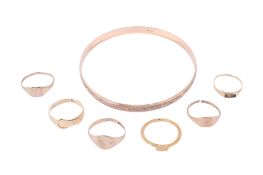 Six 9ct gold and yellow metal rings and a gold bangle.