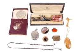 A small group of jewellery and a coin.
