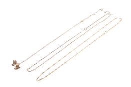 Two broken 9ct gold chains and a pig pendant on a chain.