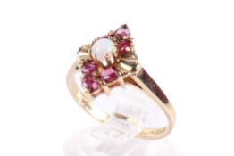 A 9ct gold opal and garnet dress ring. The opal circa 3.