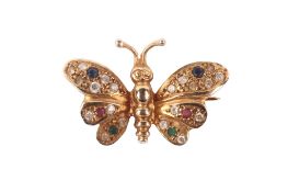 A yellow metal butterfly brooch.