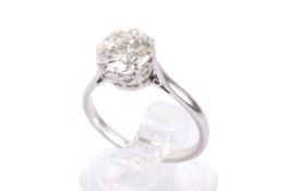 A platinum and diamond solitaire ring. Set with a round brilliant cut diamond of 1.