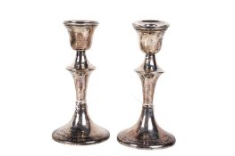 A pair of early 20th century weighted silver candlesticks.