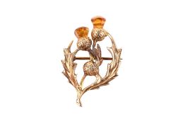 A yellow metal brooch with thistle motif. Partial hallmark visible, tests as 9ct gold. 3.6cm x 2.