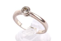 An 18ct white gold diamond solitaire ring. The round cut diamond of 0.