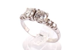 A platinum and diamond ring. The two central round cut stones of circa 0.4-0.