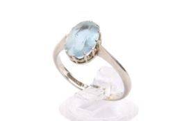 An 18ct white gold and aquamarine ring. Set with one oval faceted aquamarine of 1.