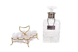 A silver collared decanter and label and a set of liqueur glasses.