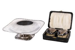 An early 20th century silver tazza and two silver brushes.