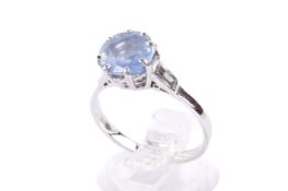A sapphire and diamond three stone ring.