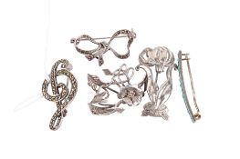Five silver and white metal brooches.
