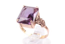 An Egyptian yellow metal and purple stone ring.