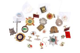 An assortment of membership badges, cufflinks and medallions.