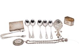 A group of assorted silver and white metal items.