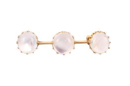 A yellow metal and moonstone bar brooch.