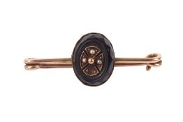 A yellow metal and bead set tie pin.