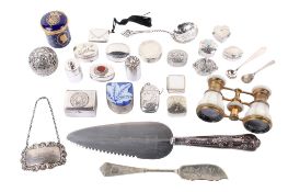 A small group of silver and white metal table items.