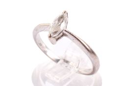A white metal diamond solitaire ring. The faceted stone of marquise form, 7mm x 3mm, circa 2.