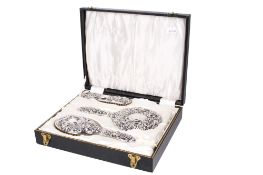 A four-piece silver mounted dressing table set.