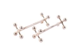 A pair of Edwardian silver knife rests. Marked Robert Stebbings, London 1905, 39.