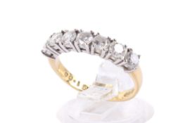 An 18ct gold and diamond ring. Set with seven round brilliant cut diamonds of 1.